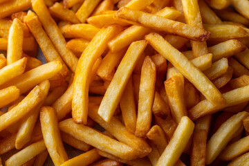 Golden fries layered to create a tasty-looking background.