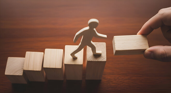 Wooden figure climbs ascending blocks while a hand places the next step symbolizing career growth mentorship and achieving future success goals