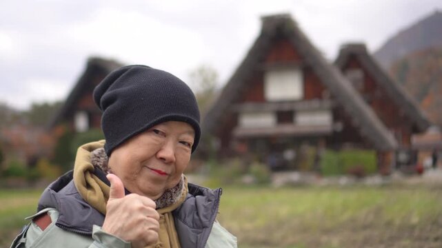 Asian senior woman travel at Shirakawa-go Gifu Japan happy tourist