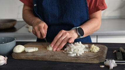 Close-Up Of A Woman Cutting Onion
