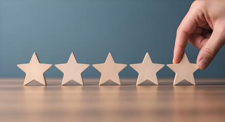 Hand placing the final wooden star in a row of five to achieve a perfect five star rating symbolizing customer satisfaction and quality assessment