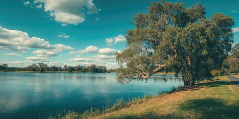 Blue sky above a lake surrounded by parkland, suitable for environmental awareness campaigns or recreation layouts, Earth Day