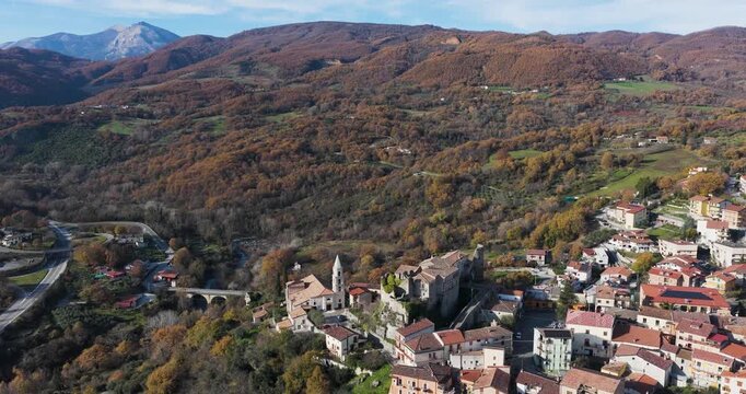 Aerial view of Episcopia nestled among rolling hills, with its terracotta rooftops contrasting against the autumn foliage, Episcopia, Basilicata, Italy.