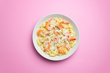 Pasta in a creamy sauce with shrimp and cheese. Italian cuisine.