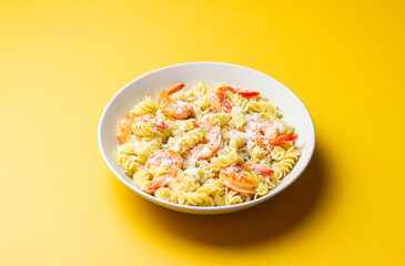 Pasta in a creamy sauce with shrimp and cheese. Italian cuisine.