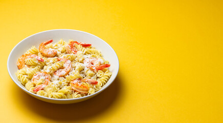 Pasta in a creamy sauce with shrimp and cheese. Italian cuisine.