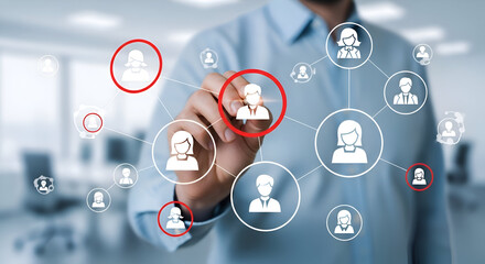 Professional hand interacting with a digital network of connected user icons highlighting key personnel selection for human resources management strategy