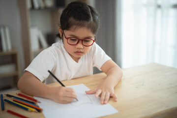 Young Girl Drawing at Table in Bright, Cozy Indoor Environment