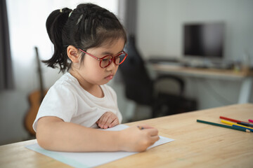 Young Girl Drawing with Pencils at Home Workspace in Bright Room