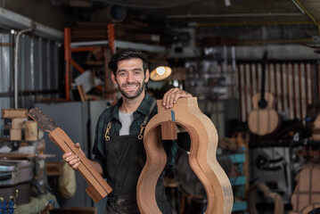 Luthier making top of guitar using traditional tools in workroom with manual tools.