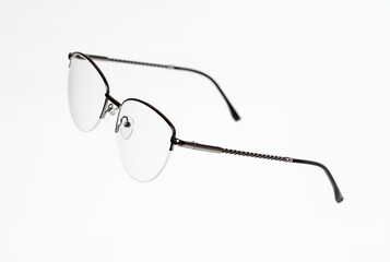 Stylish women’s eyeglasses with thin metal semi-rim frame on white background. Vsion correction...