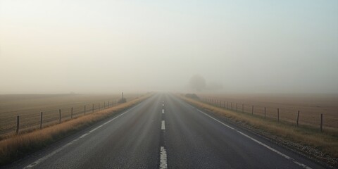 Fototapeta premium Serene summer morning scene with a foggy tarmac road in rural countryside, emphasizing tranquility and natural beauty