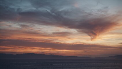 Fototapeta premium Overcast winter sunset casting muted light across a landscape, highlighting seasonal variation, Earth Day