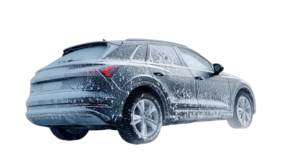 Dark SUV coated in white snow and ice, isolated on black background