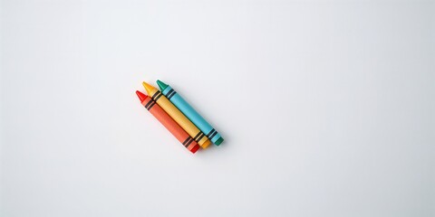 Naklejka premium Grouping of four vibrant crayons placed on a white surface, suitable for creative design, school supplies, International Creativity Month