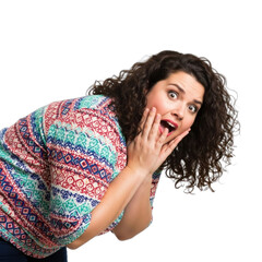 Surprised woman expressing shock with hands on face, showcasing emotions and vibrant sweater in studio setting