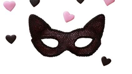 A dark, textured cat-ear mask on a black background, with scattered hearts