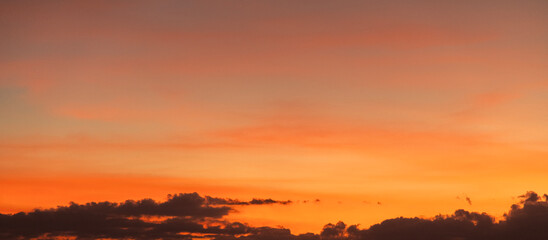 Dramatic sunset sky with clouds. Evening sky colors.