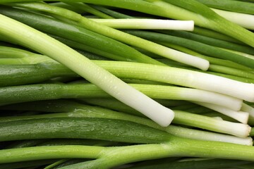 Many fresh green onions as background, closeup