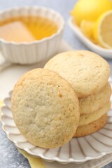 Tasty lemon cookies on grey table, closeup