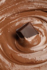 Tasty melted chocolate and piece as background, closeup