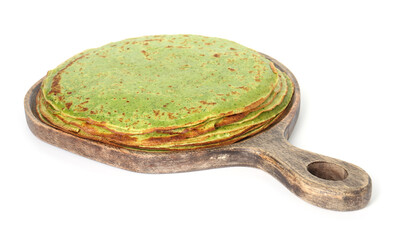 Stack of tasty spinach crepes isolated on white