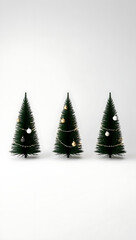 Three simple and modern miniature Christmas trees, isolated on a clean, light grey background.