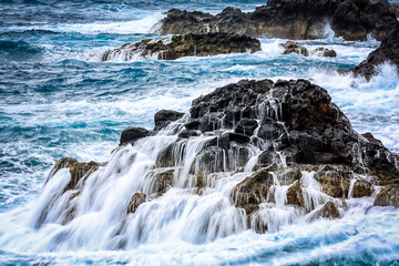waves of the atlantic ocean on the rocks of madeira