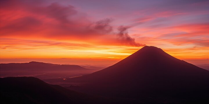 Colima's Volcano illuminated at sunset, emphasizing geological features and atmospheric glow