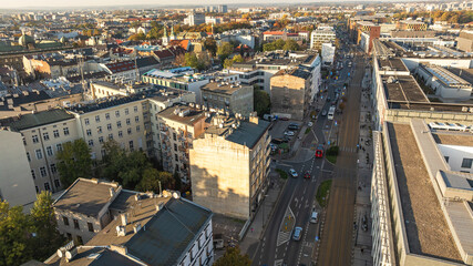 Krakow, Poland. Historic architecture, residential blocks, busy streets with warm morning light.
