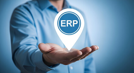 Businessman presents enterprise resource planning concept symbolized by an illuminated map pin icon held above an open hand against a blue background