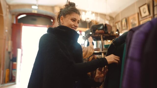 Woman pleasantly explores timeless jackets at shop store