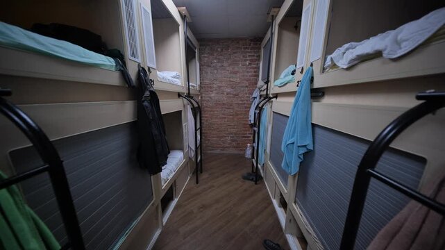 Rows of capsule beds in modern hostel dormitory offering comfortable and affordable accommodation