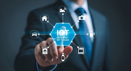 Businessman interacts with a glowing digital interface displaying iot internet of things connectivity icons for smart home devices automotive and personal technology systems