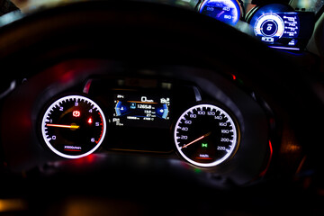 Digital instrument cluster inside the car,Digital and analog speedometer of racing cars,A close up of a speedometer inside a car, showing the speed dial reaching high numbers as the vehicle.