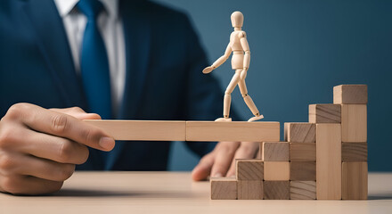 Businessman supports wooden figure crossing gap using blocks symbolizing mentorship guidance and career progression toward success goals