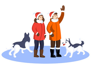 A couple in winter clothes with their two pet dogs enjoying a winter holiday.