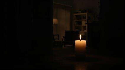 Light source from a candle during a power failure at home, highlighting safety measures