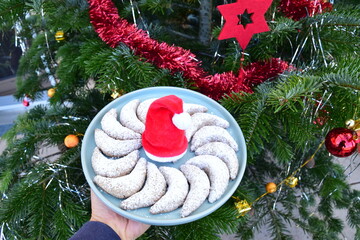 Vanillekipferl, traditional German cookies. Christmas tree at the background