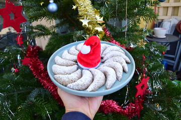Vanillekipferl, traditional German cookies. Christmas tree at the background