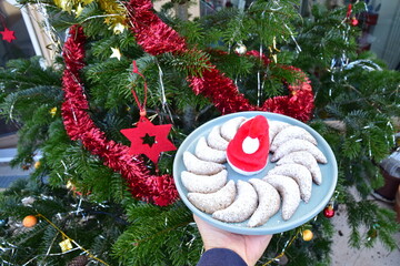 Vanillekipferl, traditional German cookies. Christmas tree at the background