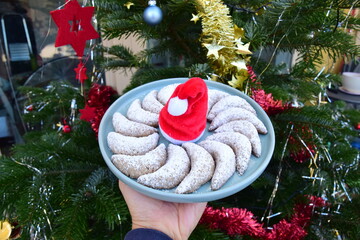 Vanillekipferl, traditional German cookies. Christmas tree at the background