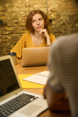 Caucasian woman contemplating while looking at the screen