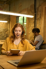 Woman reading from her phone at a desk