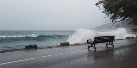 Empty bench overlooking a stormy seaside with crashing waves in a Dalmatian coastal town during off-season, weather and atmosphere