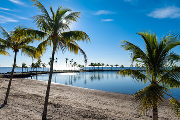 Aerial view of tropical lagoon next to the ocean during beautiful sunrise and blue sky