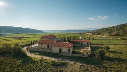 Naklejka premium Sunlit summer scene over a Molokan village with traditional buildings, highlighting rural architecture in Lori Province