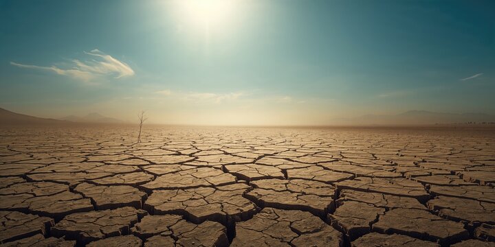 Dry cracked earth surface indicating drought conditions, climate change and water scarcity awareness