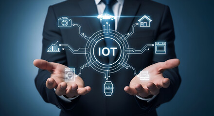 Businessman presenting internet of things iot concept with connected devices and icons floating above his hands in a futuristic dark background