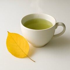Bright yellow leaf around an green tea on the white Surface